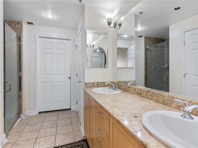 bathroom with vanity, tile patterned flooring, and a shower with door