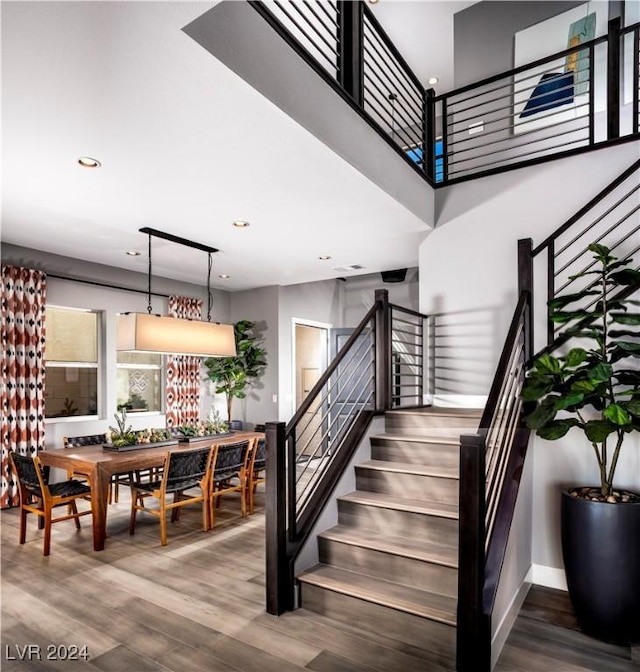 staircase with hardwood / wood-style floors