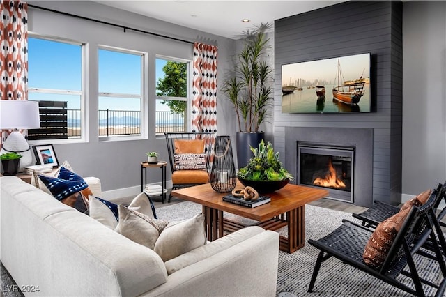 living room featuring hardwood / wood-style floors and a large fireplace