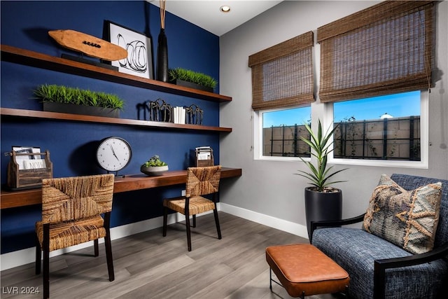 office area with built in desk and wood-type flooring