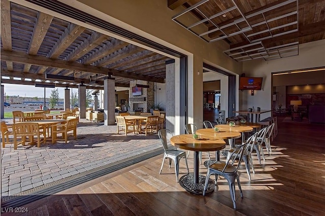 interior space with an outdoor stone fireplace and a pergola