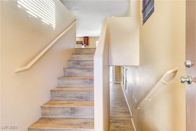 stairway featuring wood-type flooring