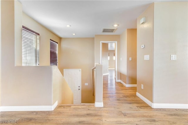 hallway with light hardwood / wood-style flooring