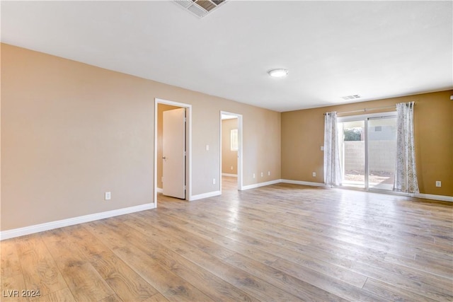 unfurnished room with light wood-type flooring