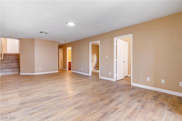 unfurnished room with light wood-type flooring