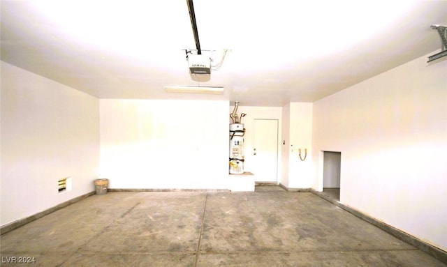 garage with secured water heater and a garage door opener