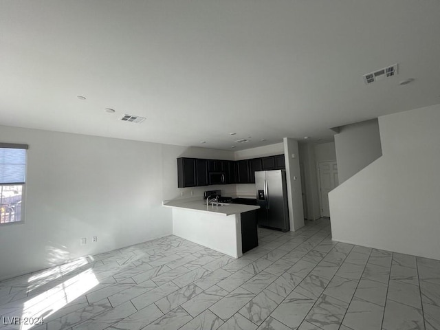 kitchen with kitchen peninsula, sink, and stainless steel appliances