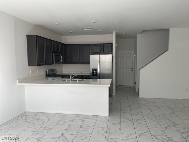 kitchen featuring kitchen peninsula, sink, and appliances with stainless steel finishes