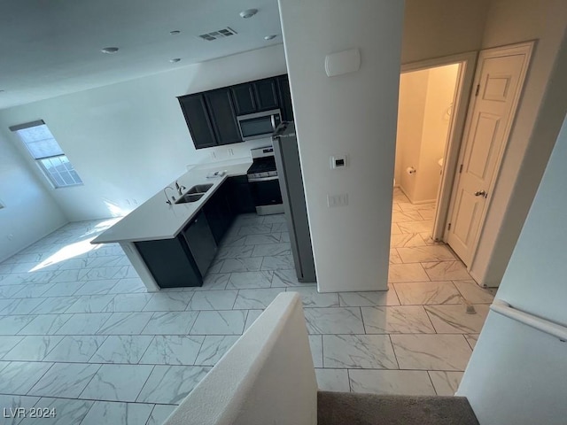 kitchen with a kitchen island, sink, and stainless steel appliances