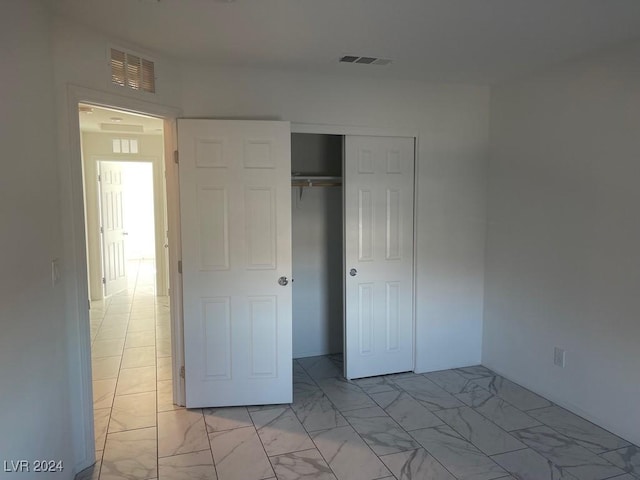 unfurnished bedroom with a closet