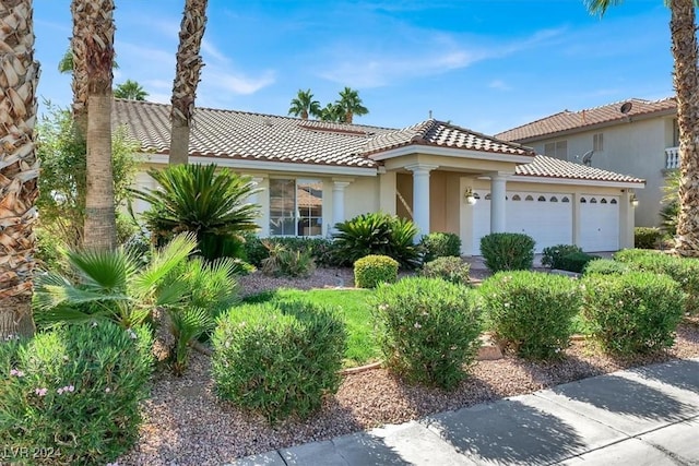 mediterranean / spanish home with a garage