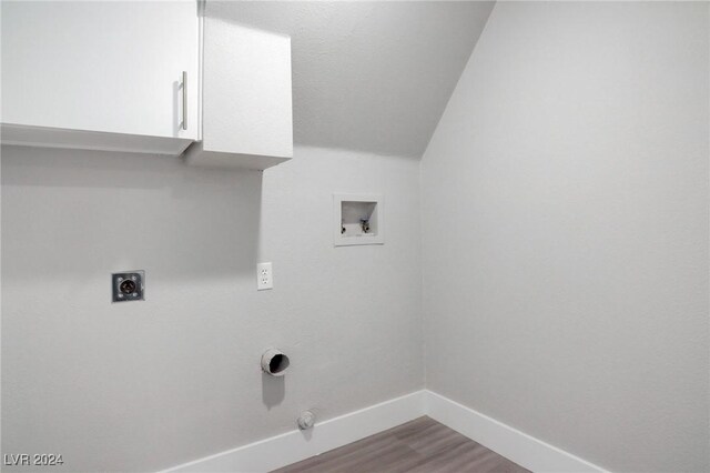 washroom with hardwood / wood-style floors, gas dryer hookup, cabinets, washer hookup, and hookup for an electric dryer