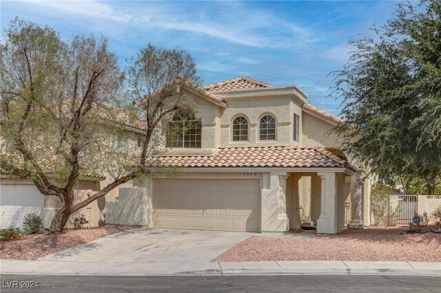 mediterranean / spanish house with a garage