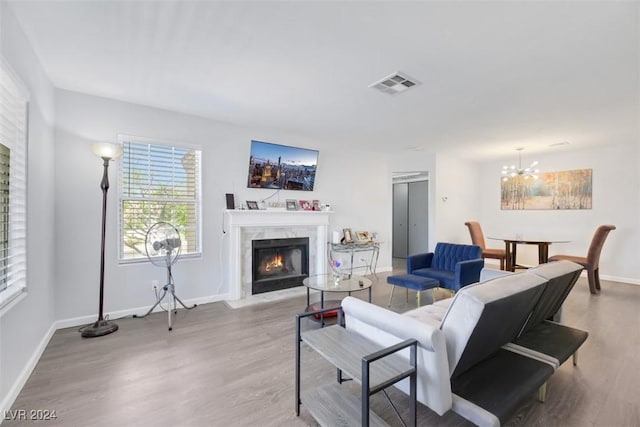 living room featuring a chandelier and wood-type flooring