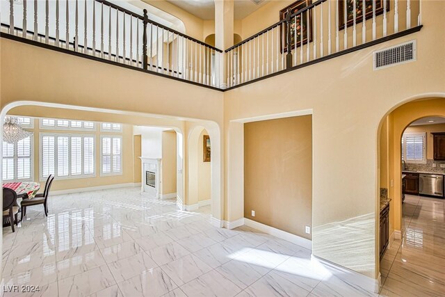 interior space featuring a towering ceiling and a chandelier