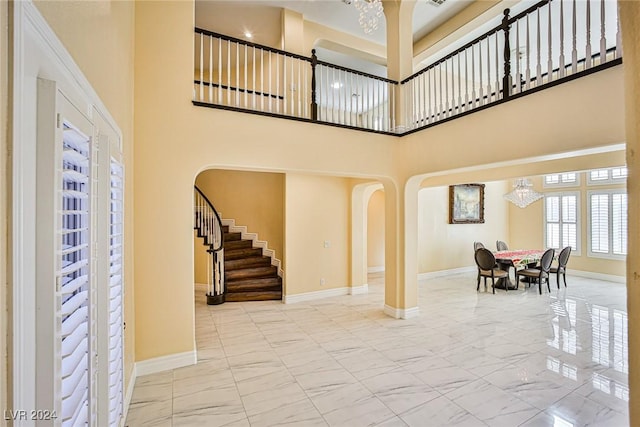 foyer with a chandelier and a high ceiling