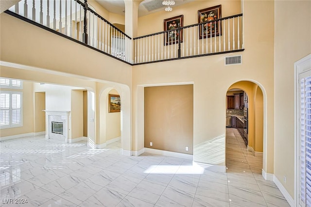 unfurnished living room with a high ceiling