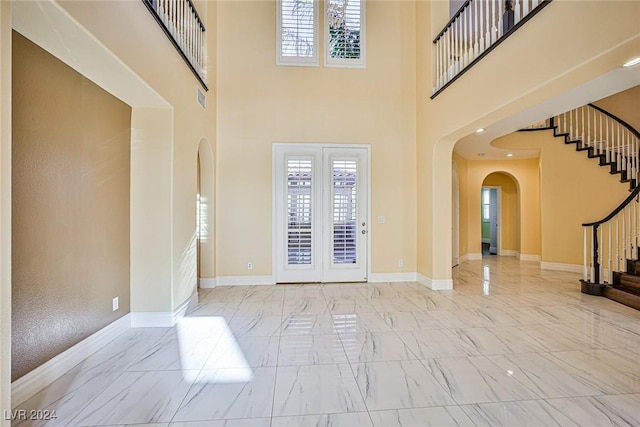 entryway featuring a towering ceiling