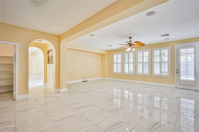 unfurnished room with plenty of natural light and ceiling fan