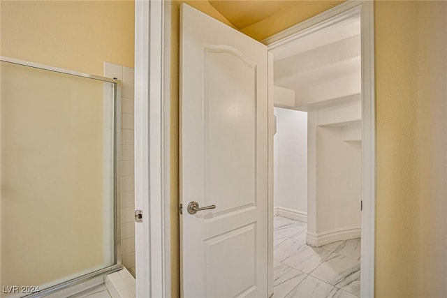 bathroom with a shower with shower door