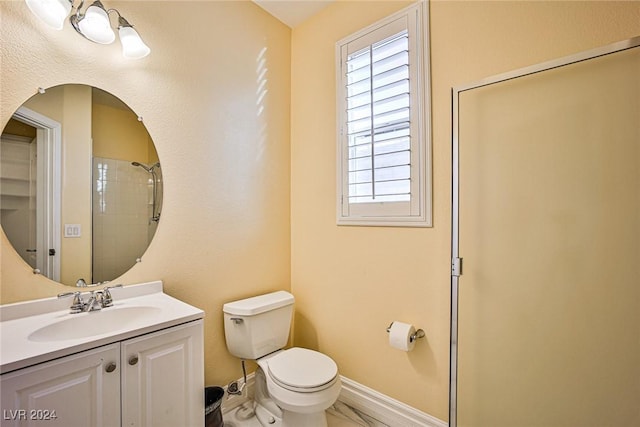 bathroom featuring vanity, toilet, and tiled shower