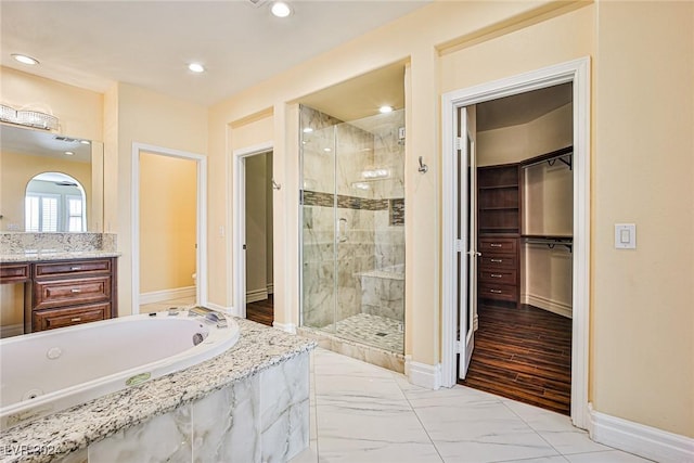 bathroom featuring hardwood / wood-style flooring, vanity, and independent shower and bath