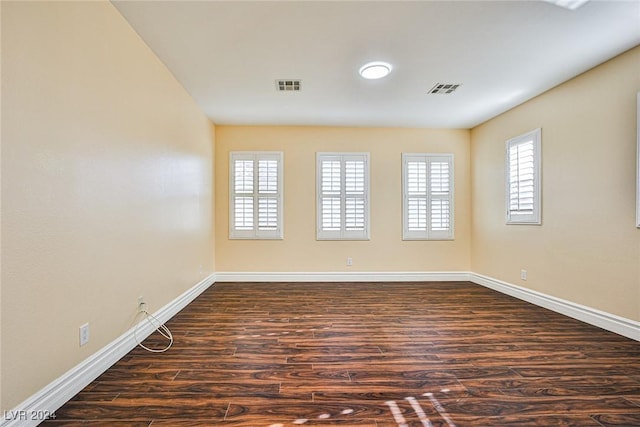 spare room with dark wood-type flooring