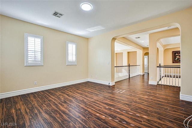 unfurnished room with dark hardwood / wood-style flooring