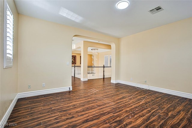 spare room with dark hardwood / wood-style flooring