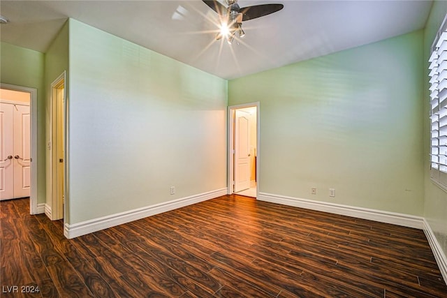 spare room featuring dark hardwood / wood-style floors and ceiling fan