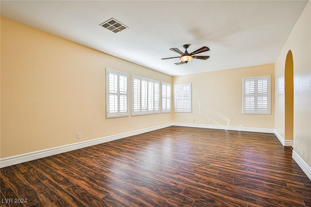 spare room with dark hardwood / wood-style flooring and ceiling fan