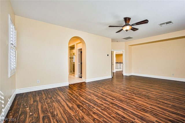 unfurnished room with ceiling fan and dark wood-type flooring