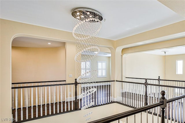 corridor with a notable chandelier