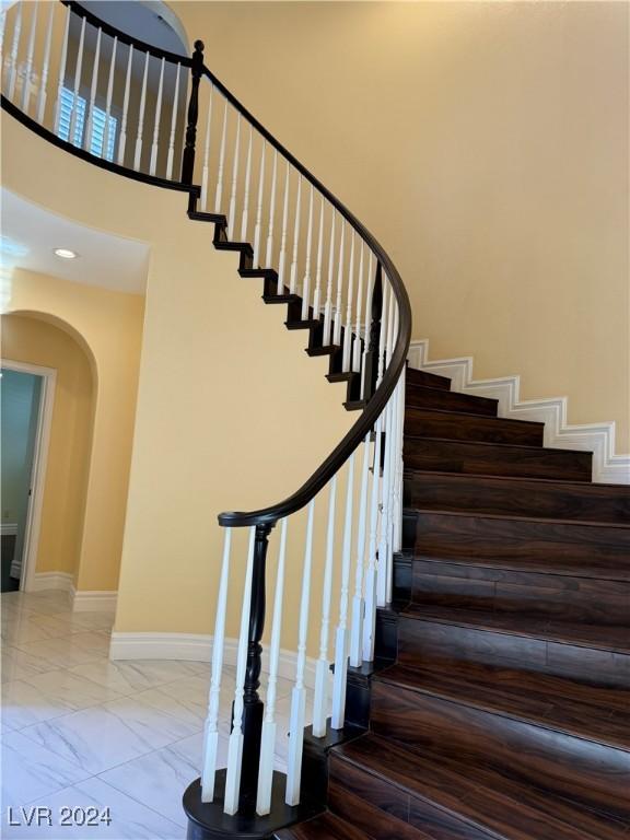 staircase featuring a high ceiling