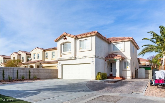 mediterranean / spanish-style home with a garage