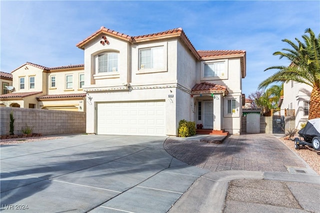 mediterranean / spanish-style home with a garage