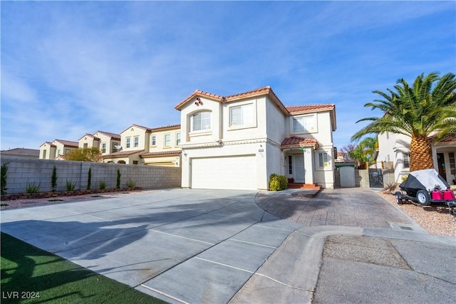 mediterranean / spanish-style home with a garage