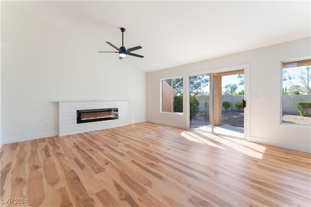 unfurnished living room with ceiling fan, a wealth of natural light, and light hardwood / wood-style flooring