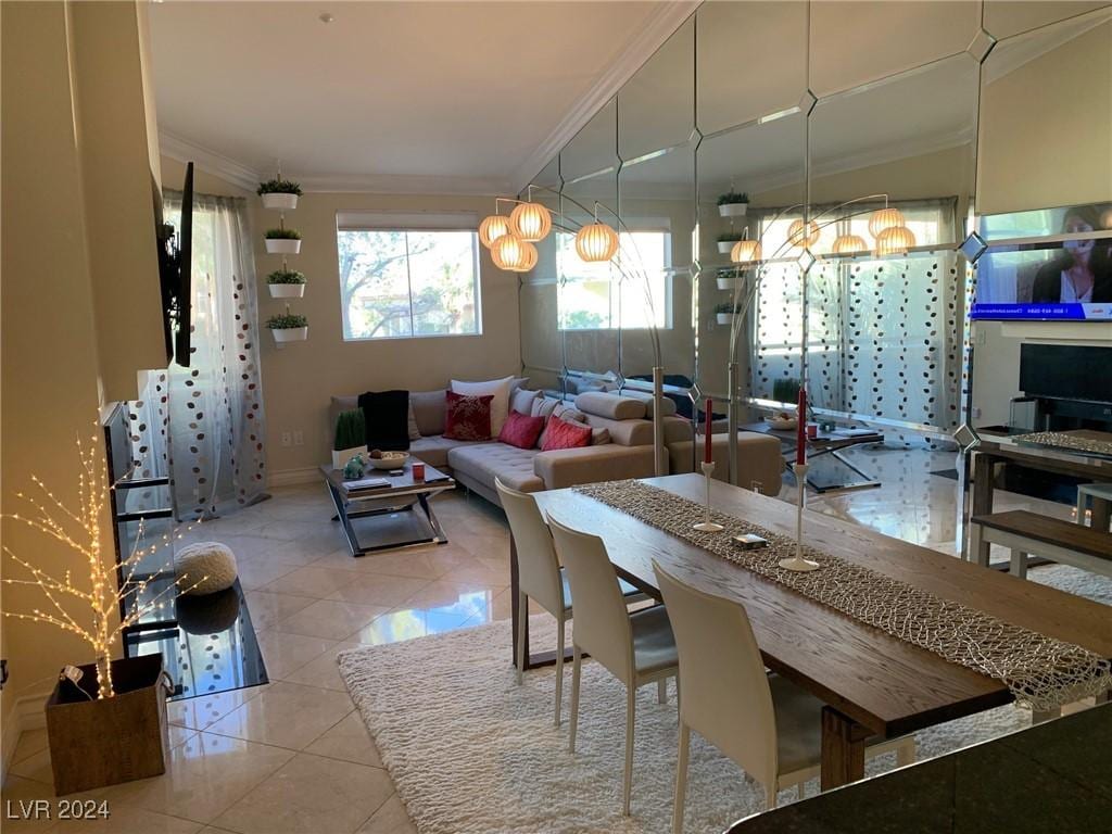 dining room with ornamental molding and light tile patterned flooring