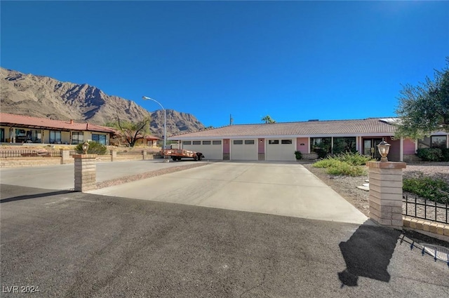 ranch-style home featuring a mountain view and a garage