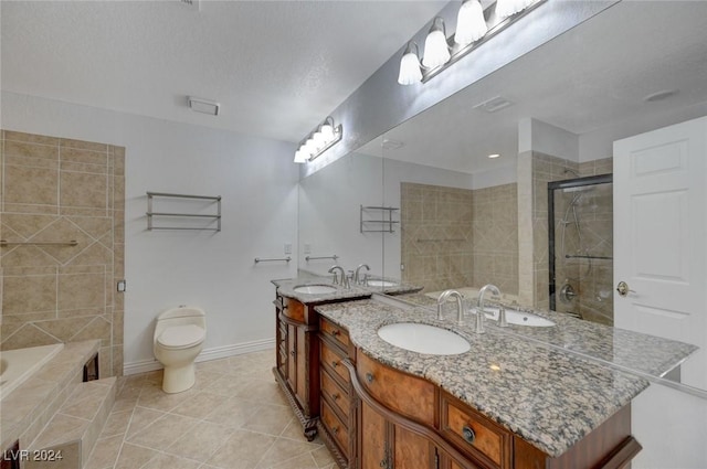 full bathroom featuring vanity, tile patterned floors, toilet, shower with separate bathtub, and a textured ceiling