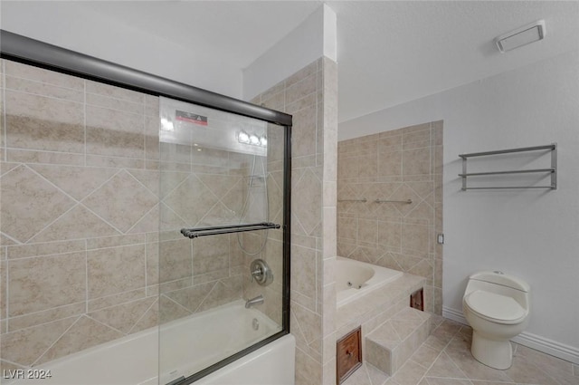 bathroom with tile patterned floors, combined bath / shower with glass door, and toilet