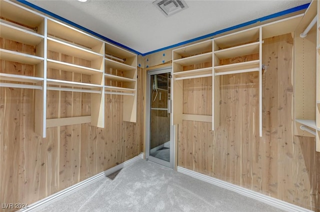 walk in closet with carpet flooring