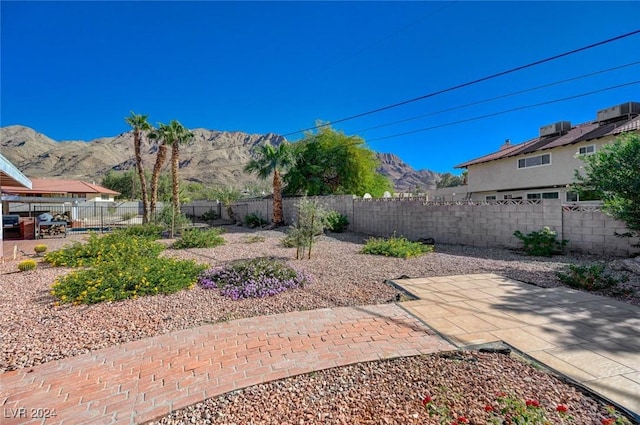 view of yard featuring a mountain view and a patio