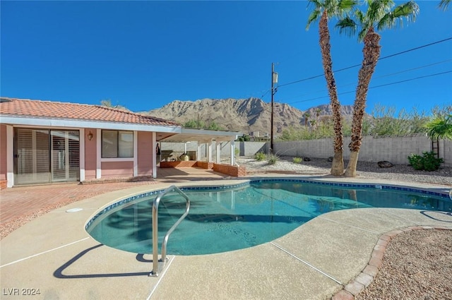 view of pool featuring a mountain view and a patio