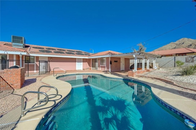 view of pool with central air condition unit and a patio area