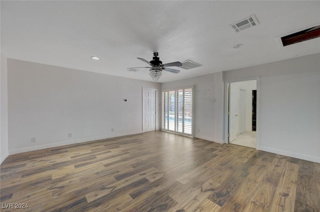 empty room with ceiling fan and hardwood / wood-style floors