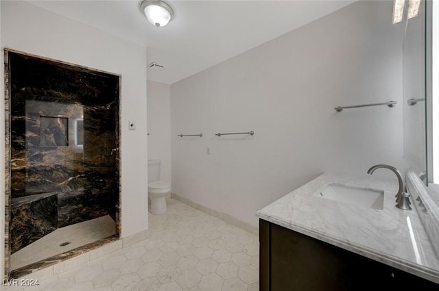 bathroom with a shower, vanity, toilet, and tile patterned flooring