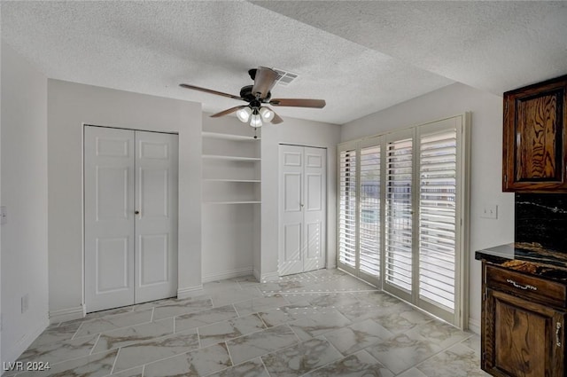 bedroom with a textured ceiling and ceiling fan