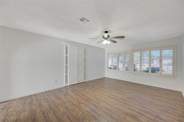 unfurnished room with ceiling fan, a textured ceiling, and hardwood / wood-style flooring